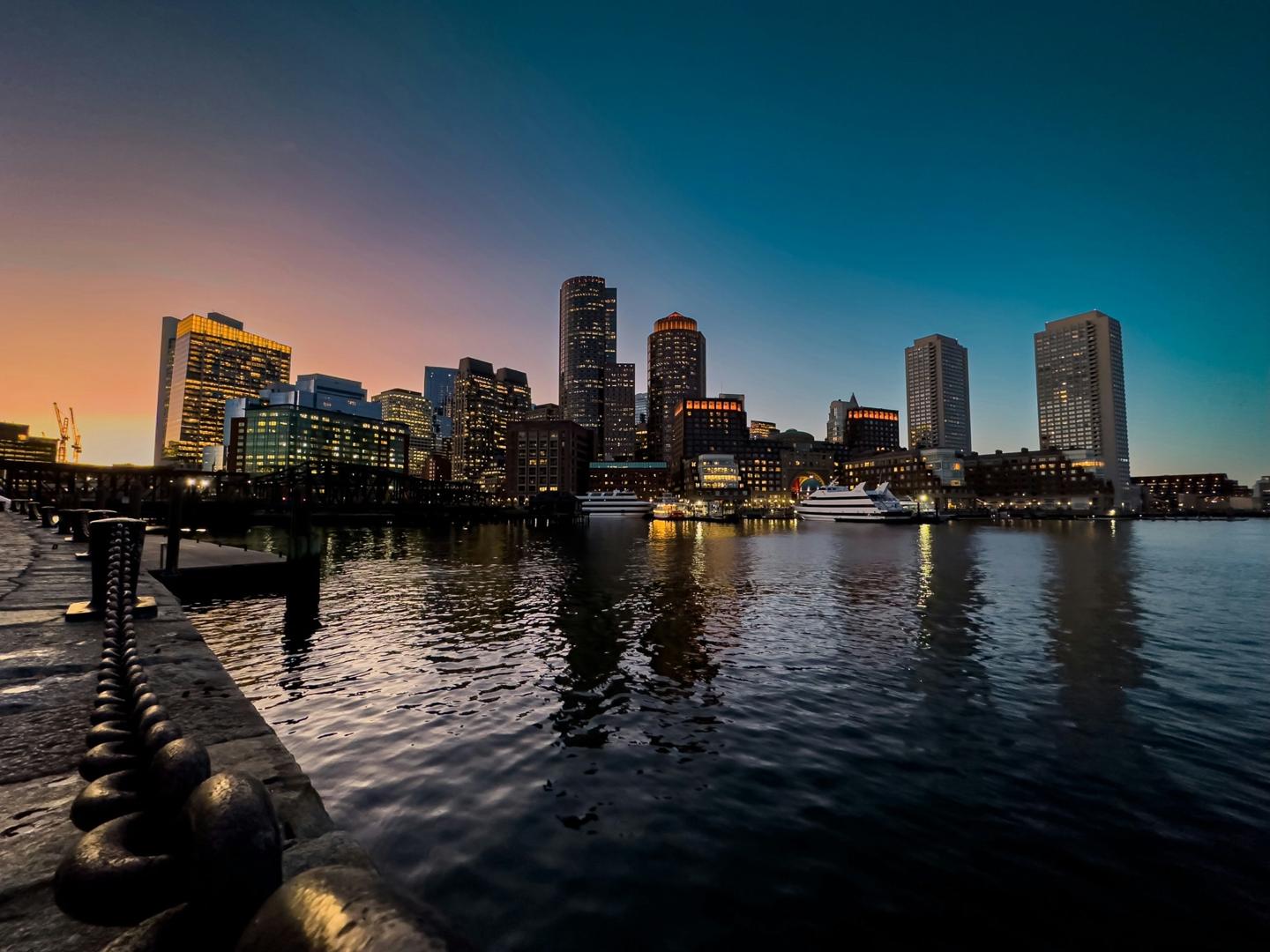 Boston skyline and harbor at dusk